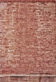Textured brickwork with warm red and brown hues on a classic exterior wall.
