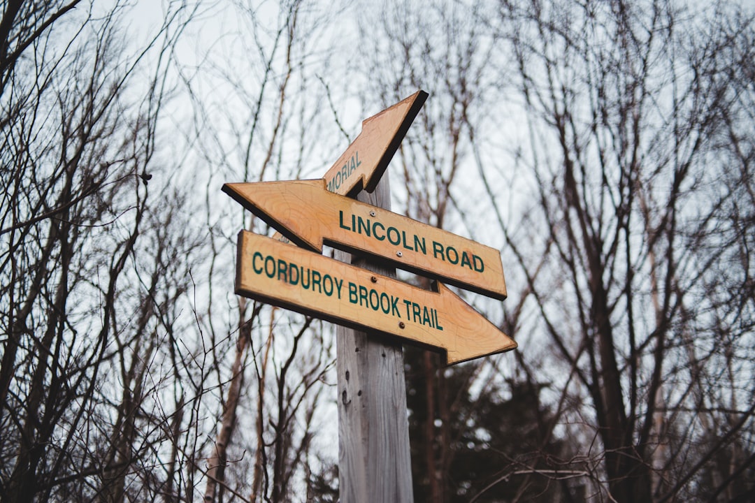 Lincoln Road and Corduroy Brook Trail wooden signage pointing on two opposite direction