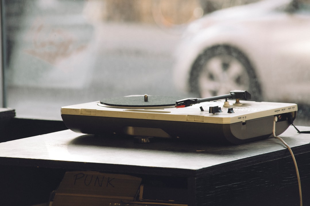 beige and black DJ turntable on black surface