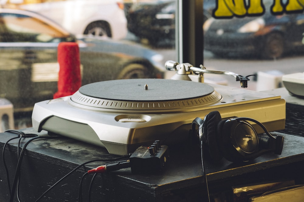 a turntable sitting on top of a table next to a window