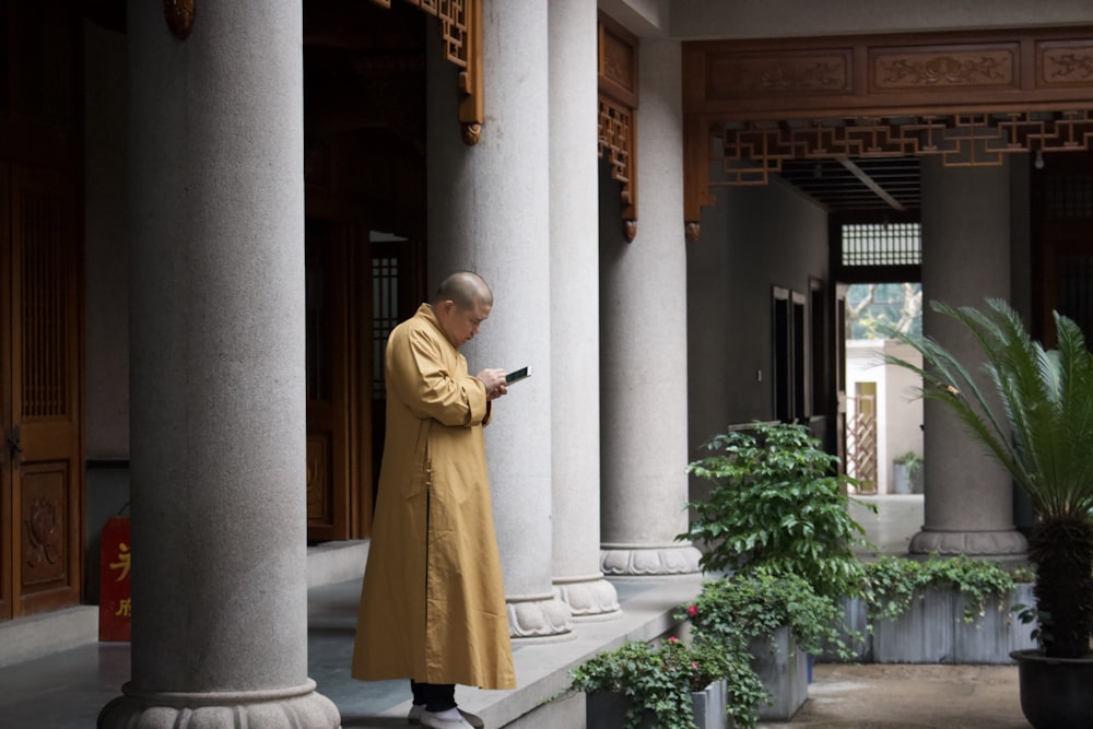 man using Android smartphone in temple