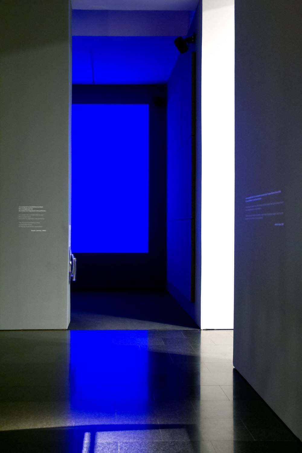 an empty room with a blue light in it