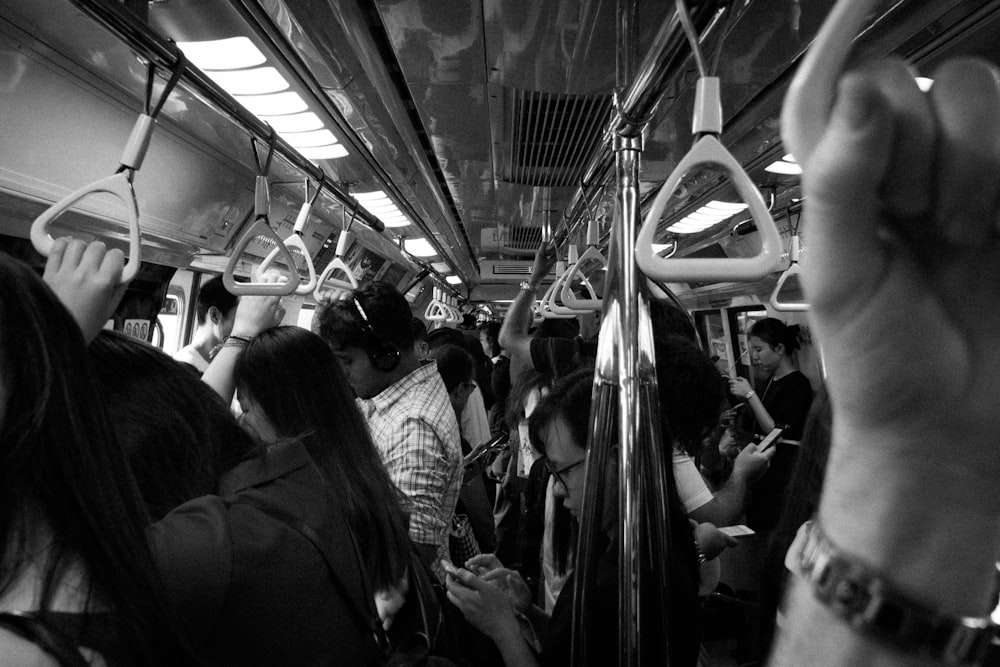 grayscale photo of people inside train