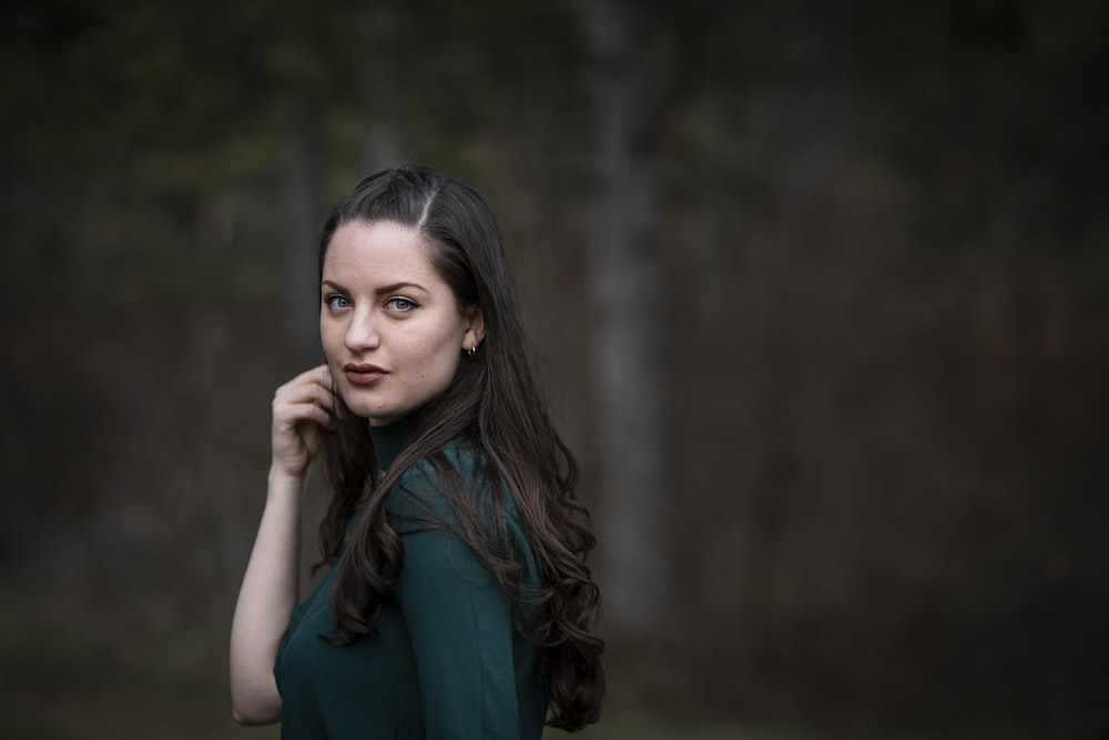 a woman in a green dress posing for a picture