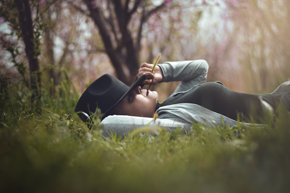 woman lying on grass field