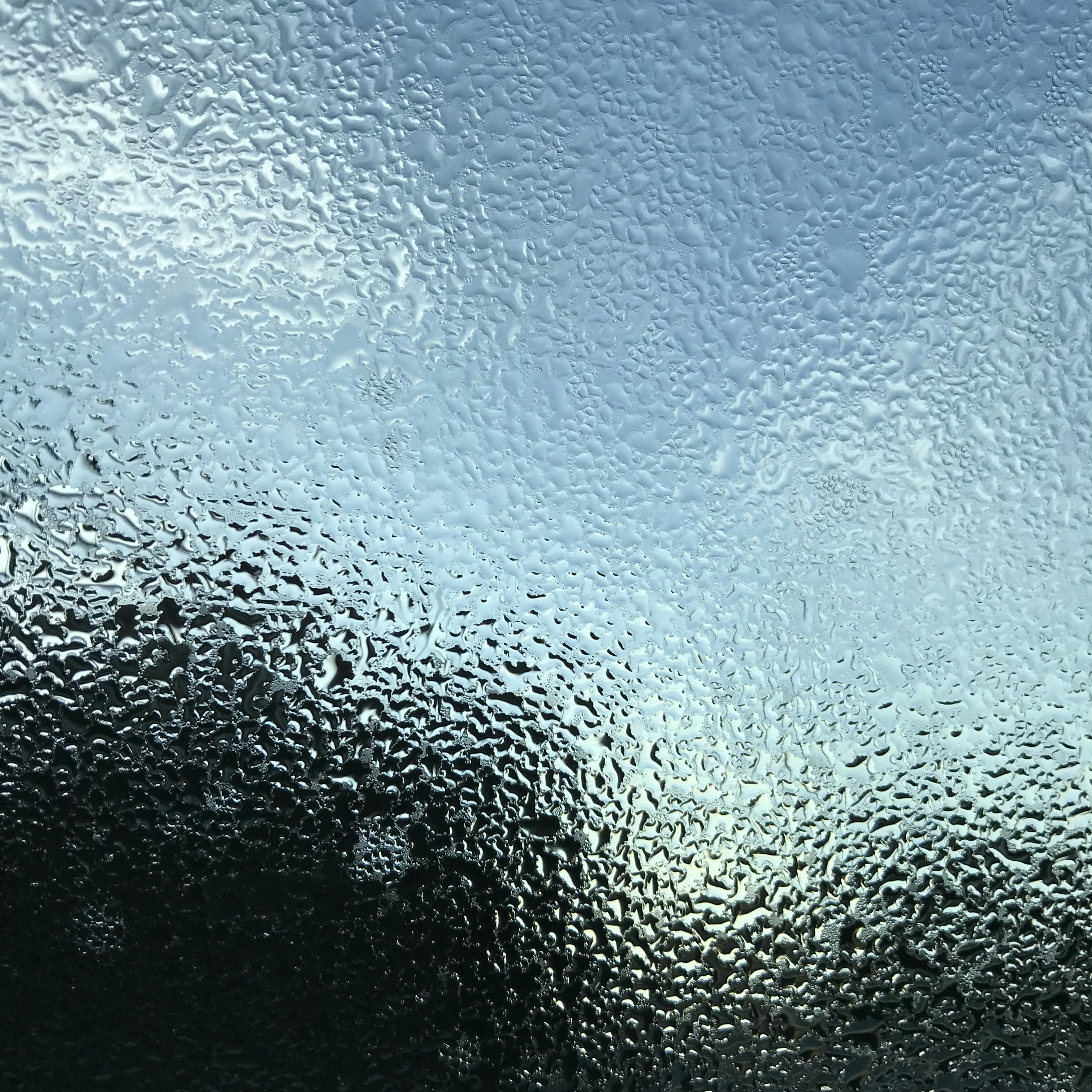 a close up of a window with rain drops on it