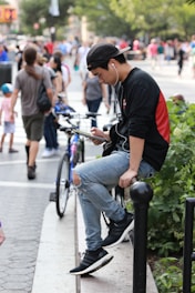 A young person enjoying music with wireless earbuds in a park.