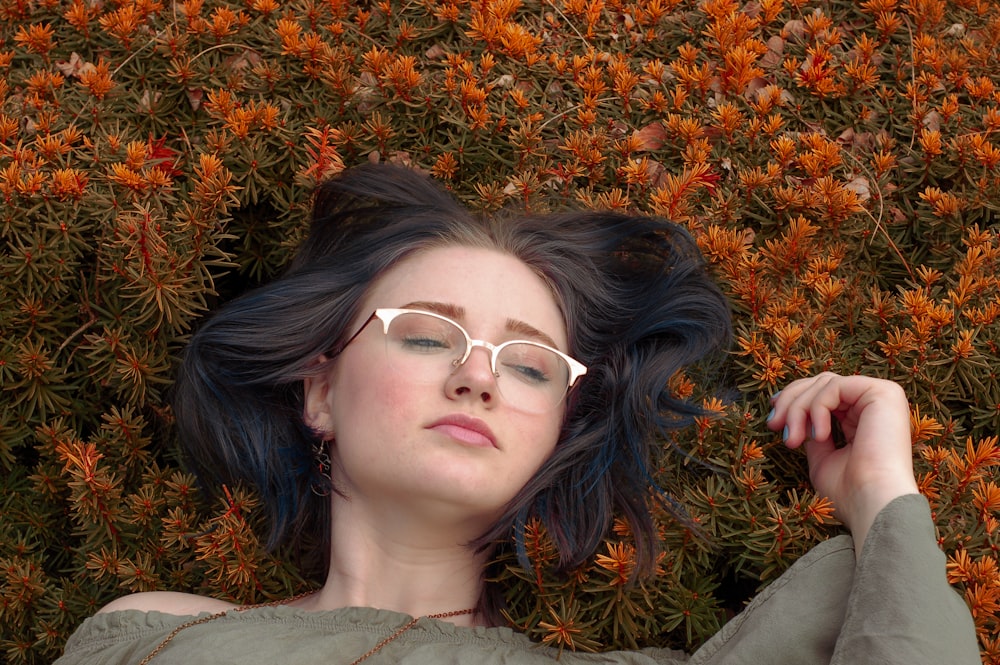woman in eyeglasses lying on field of flowers photo – Free Human Image on  Unsplash