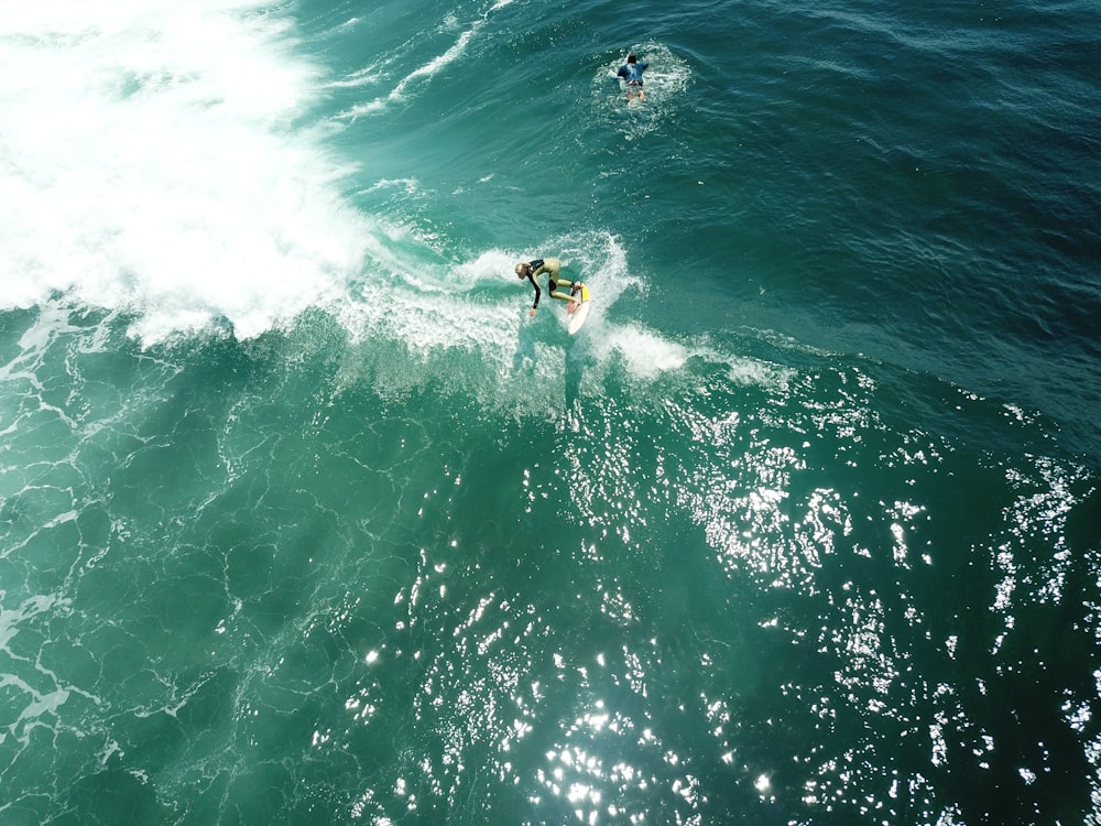 person surfing on sea waves during daytime