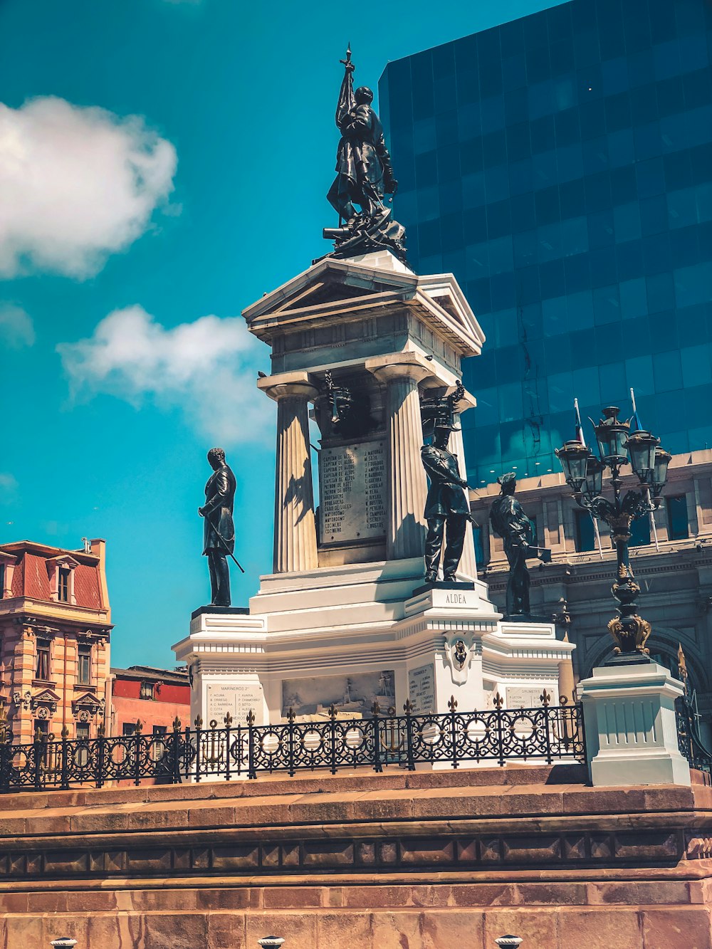 black statue of men near building