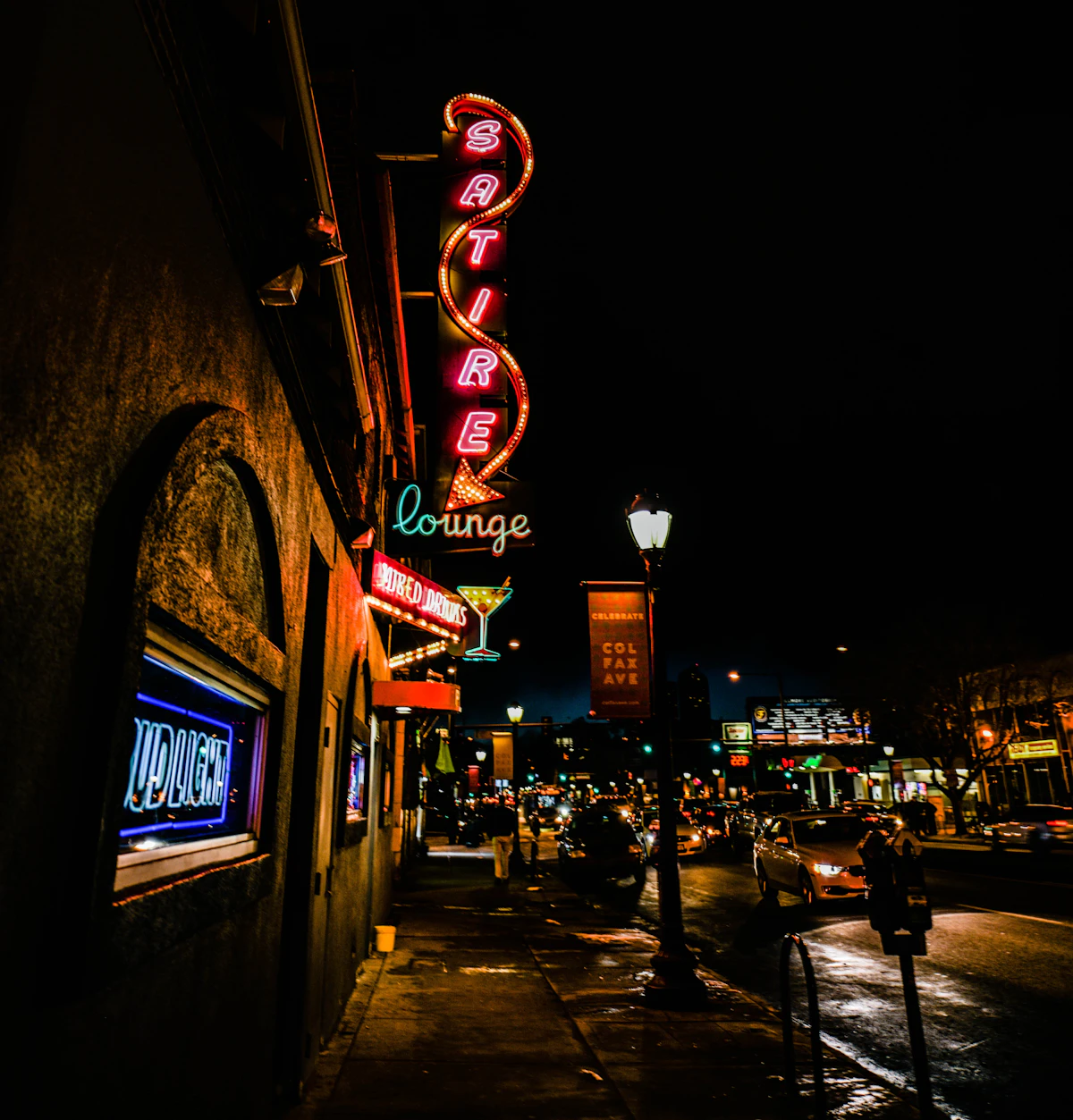 Satire Lounge neon sign on Colfax Avenue in Denver at night