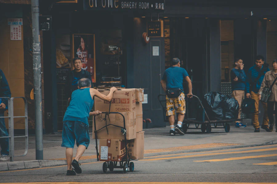 Man moving donated items on a hand truck