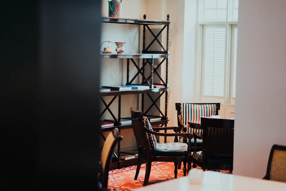 A cozy, sunlit room featuring neatly arranged colorful storage boxes from cajaviva on shelves and under tables.