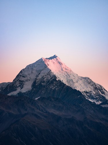 Traveler with a backpack looking out over a scenic mountain overlook