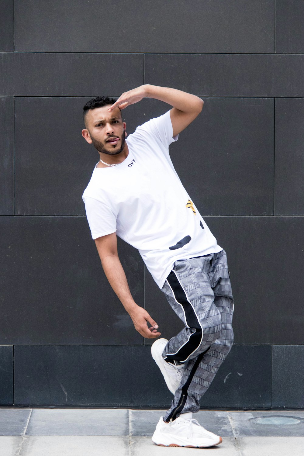 man wearing white crew-neck T-shirt and pants