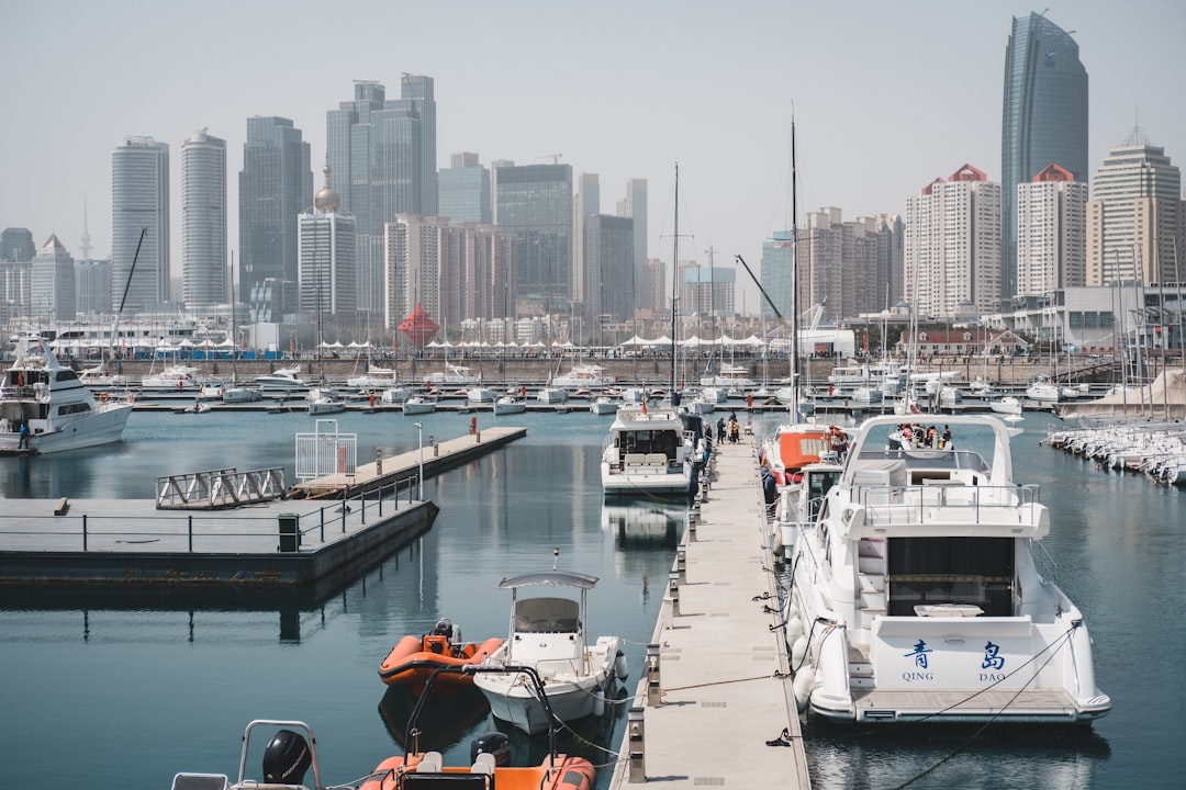 boats on calm body of water near buildings