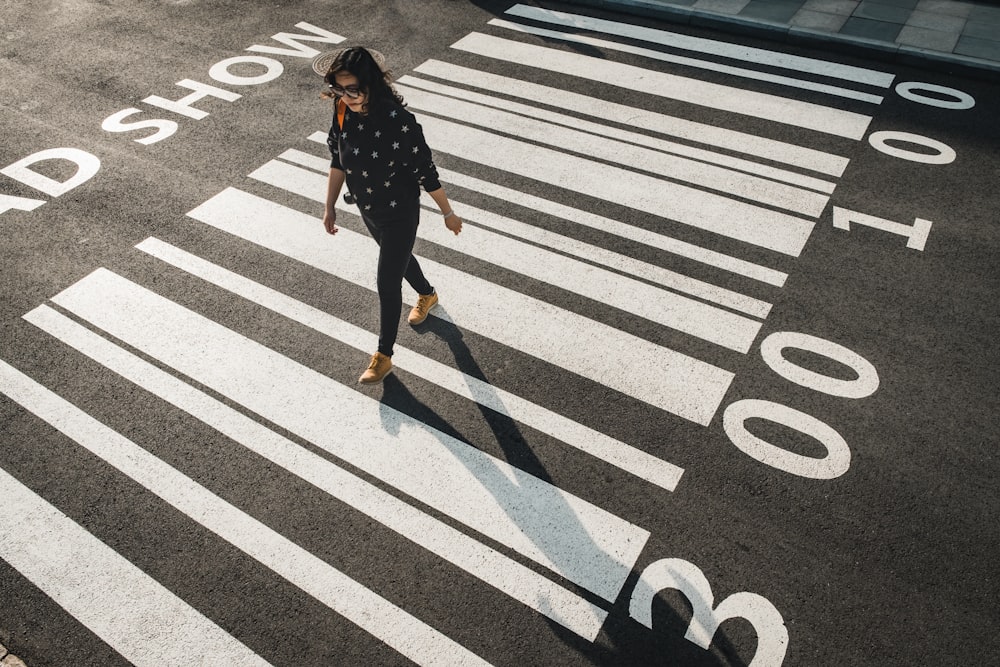 woman walking on pedestrian lane