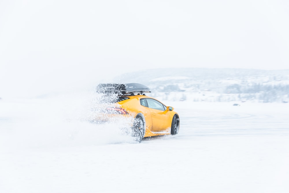 yellow coupe on snow field