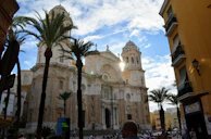 Historic cathedral in a colonial city square bathed in warm afternoon light.
