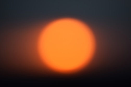 Close-up of a glowing sun icon integrated into a clean web page layout.