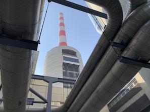 A panoramic view of a power plant boiler with visible refractory lining and waste heat recovery systems
