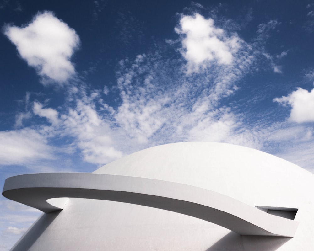 a white building with a blue sky in the background