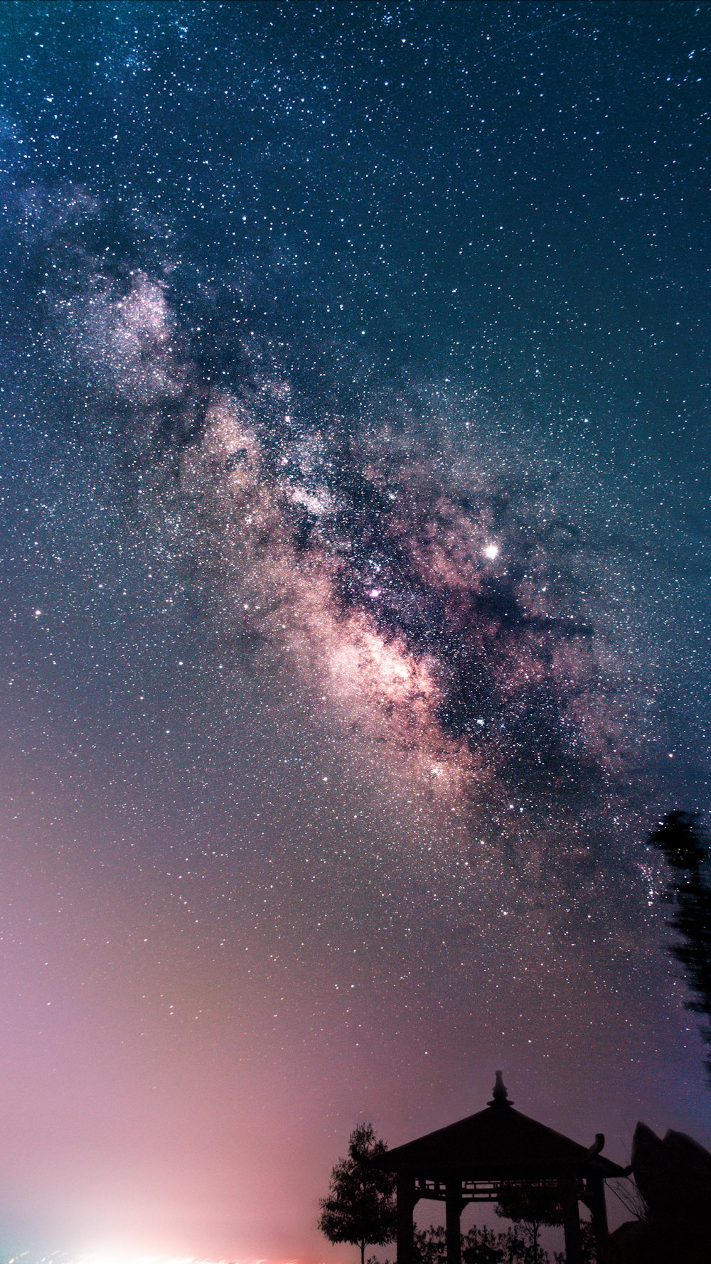 silhouette of gazebo under night sky