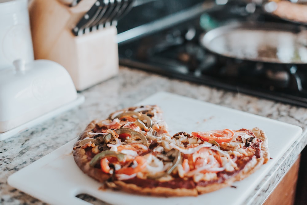 pizza on white chopping board