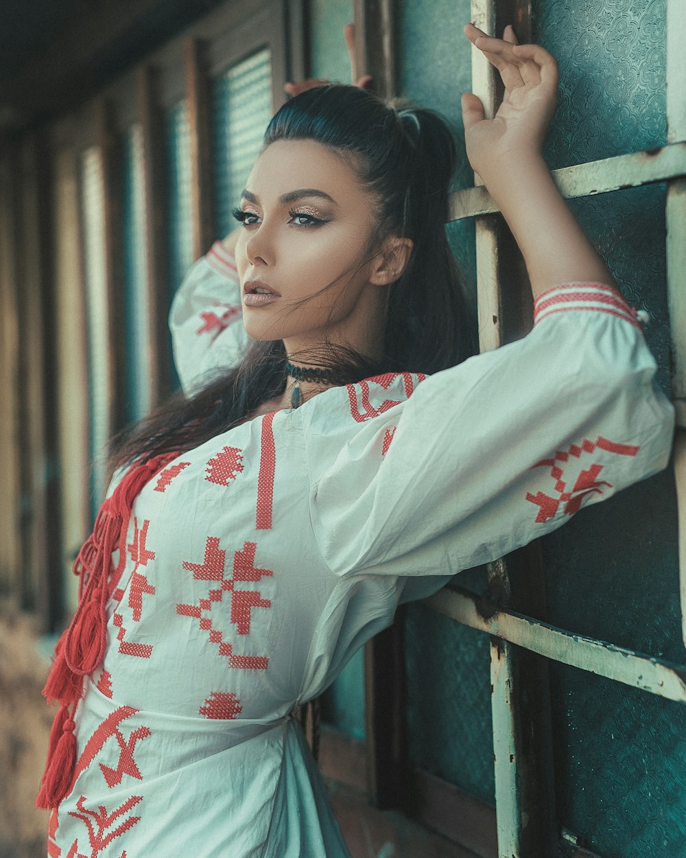 woman standing against the wall and leaning her both hands