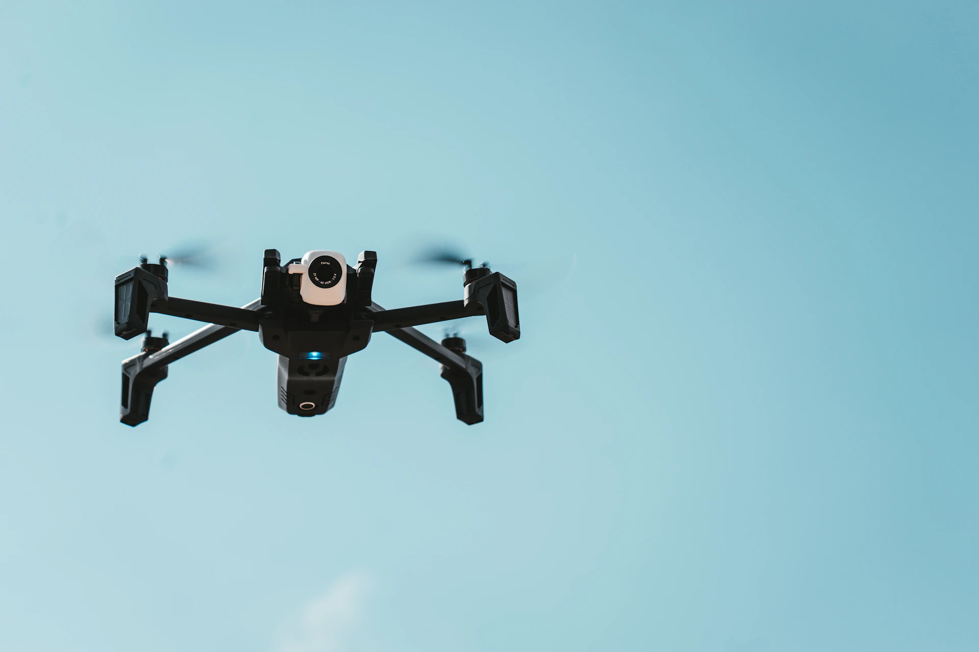 black drone flying on sky
