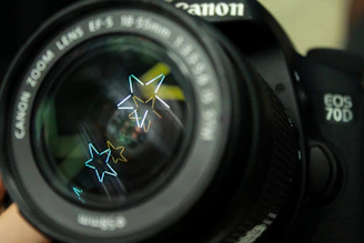 Close-up of a vintage camera lens with the Skar Studios logo reflected in the glass.