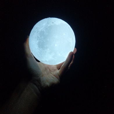 person holding glow-in-the-dark ball