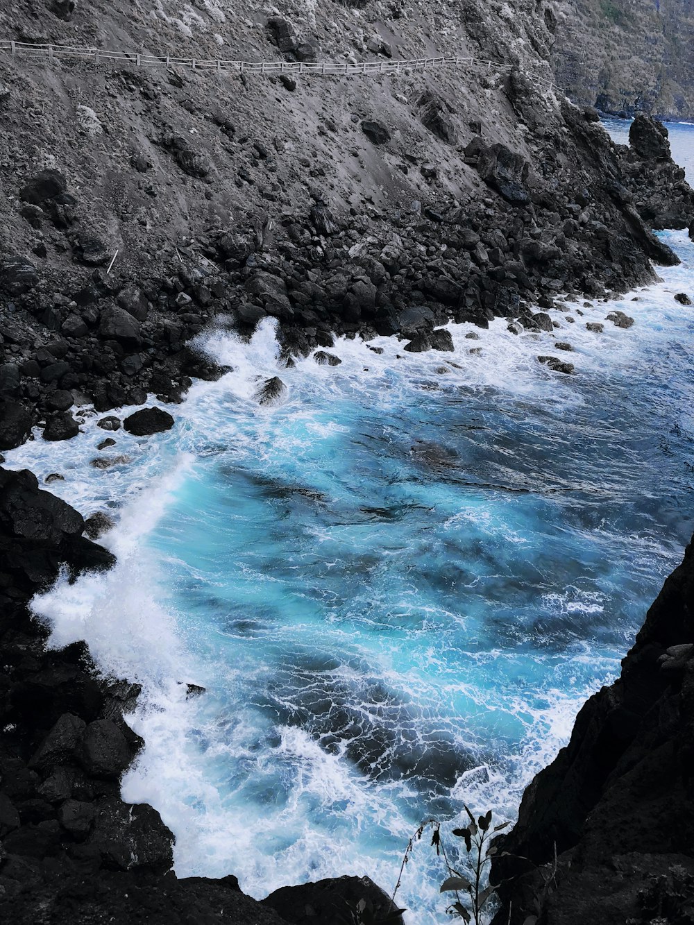 black rock formation beside seashore