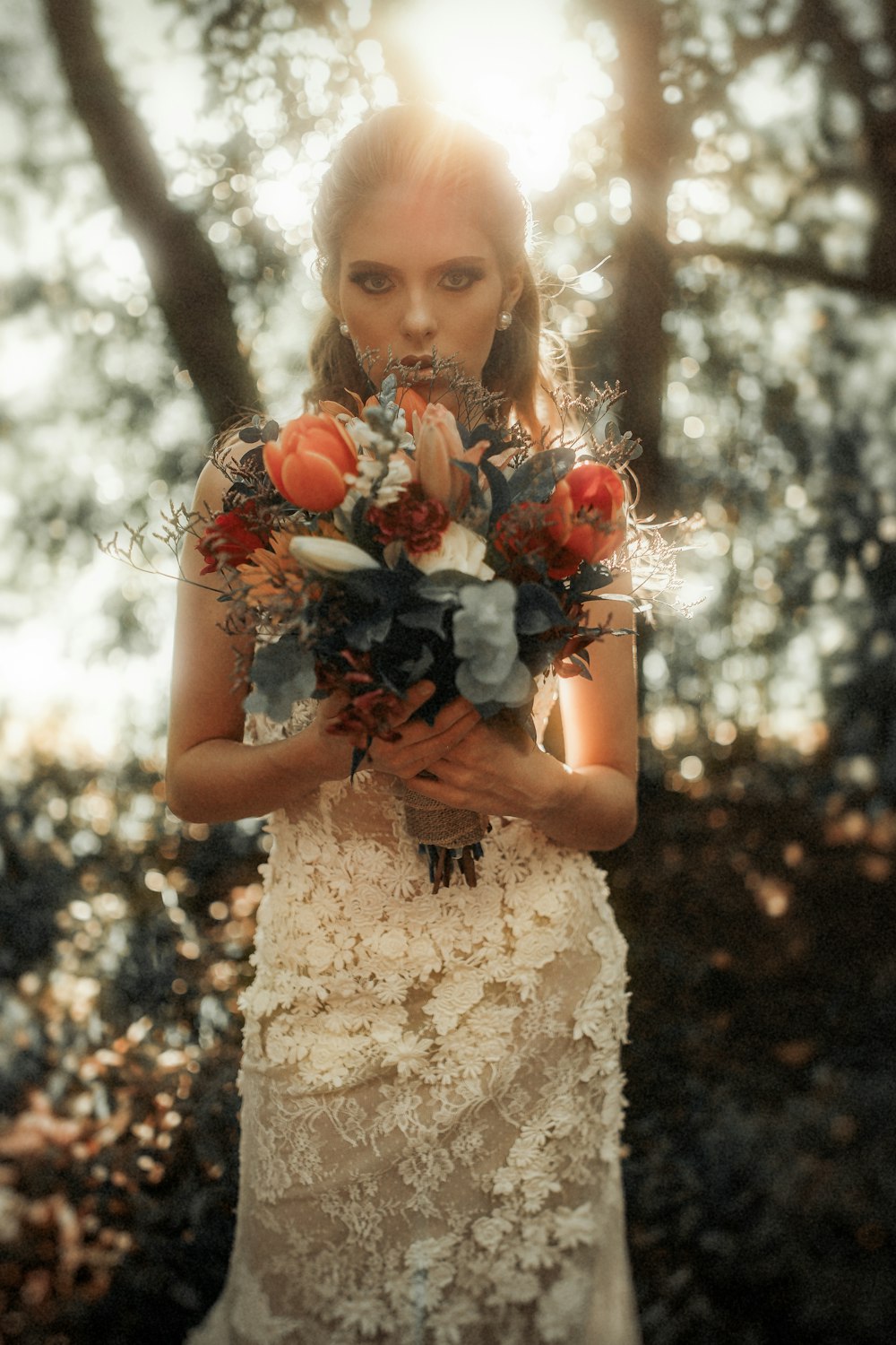 a woman in a white dress holding a bouquet of flowers