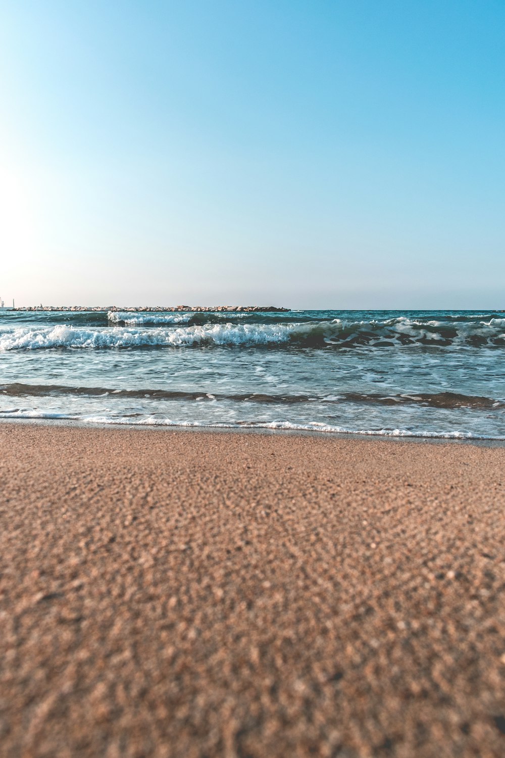 brown sand beside seashore