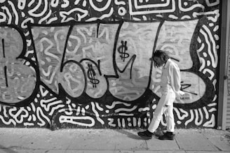 woman walking beside wall