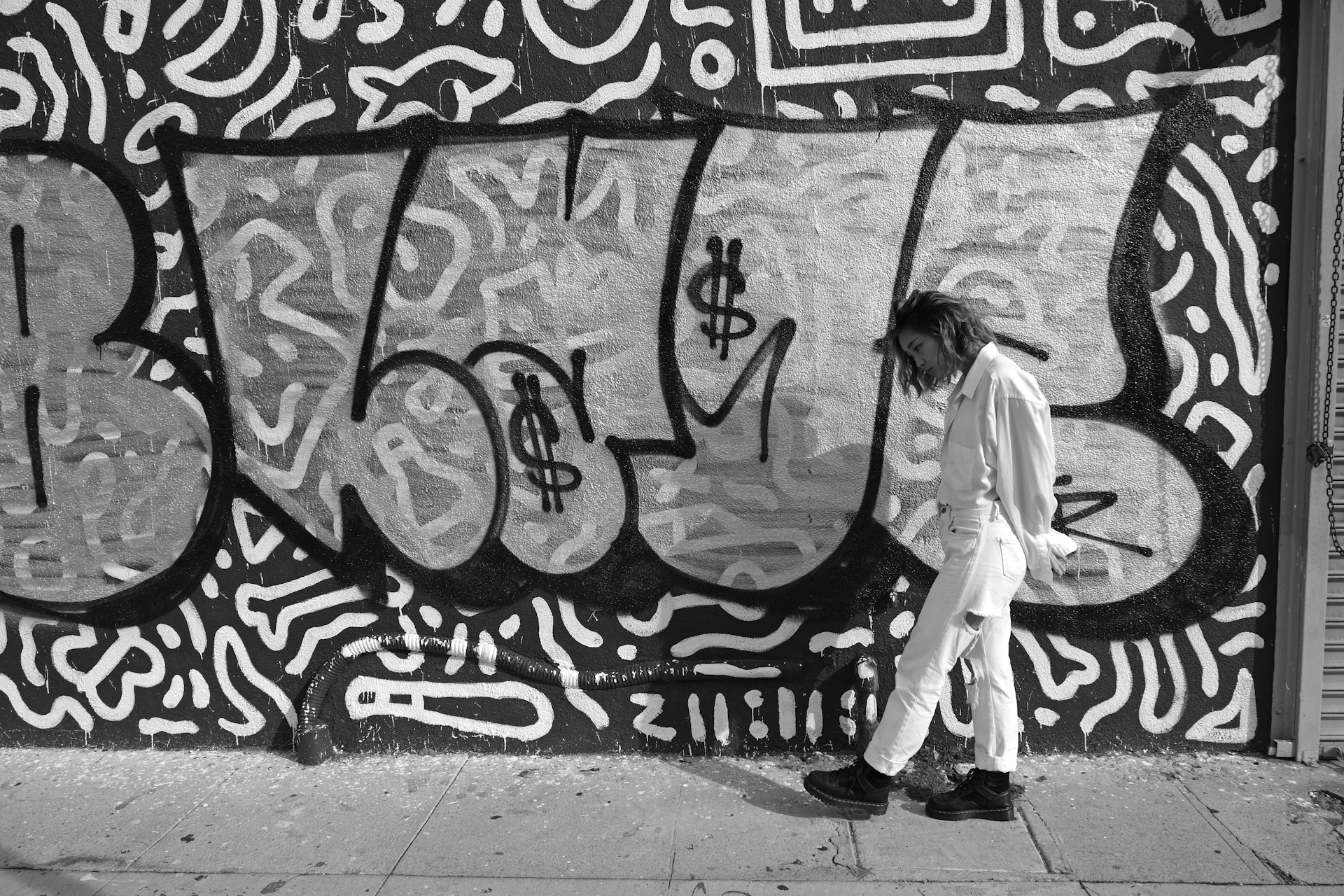 woman walking beside wall