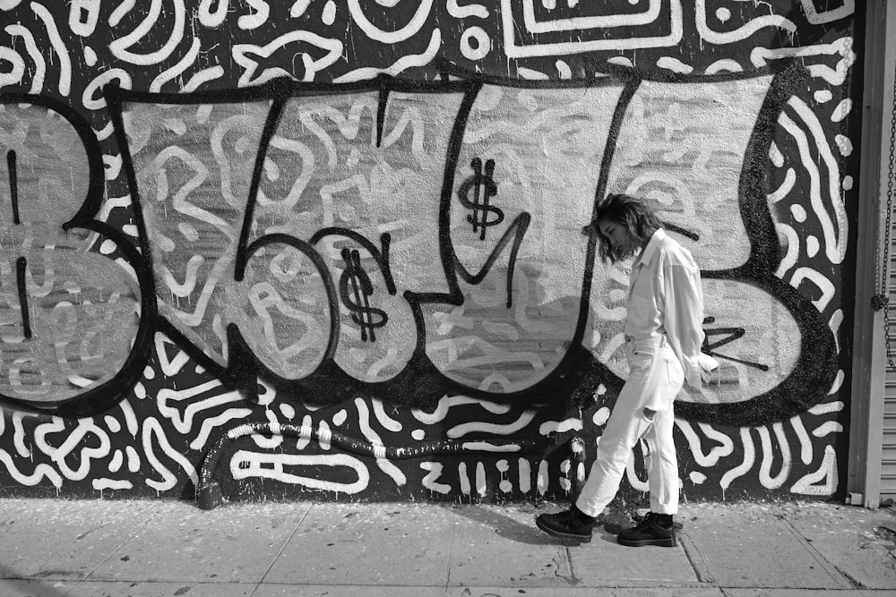 woman walking beside wall