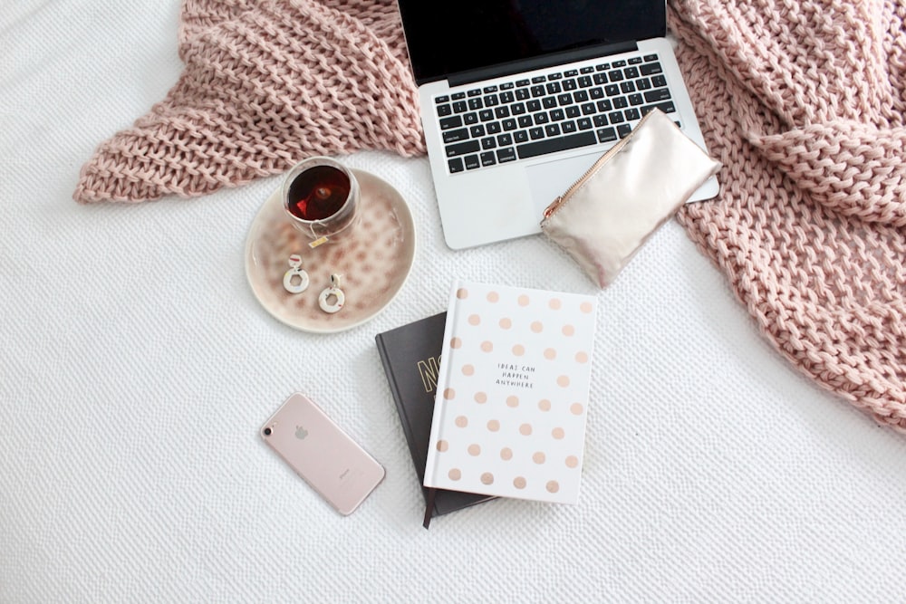 flat lay photography of iPhone beside books and plate