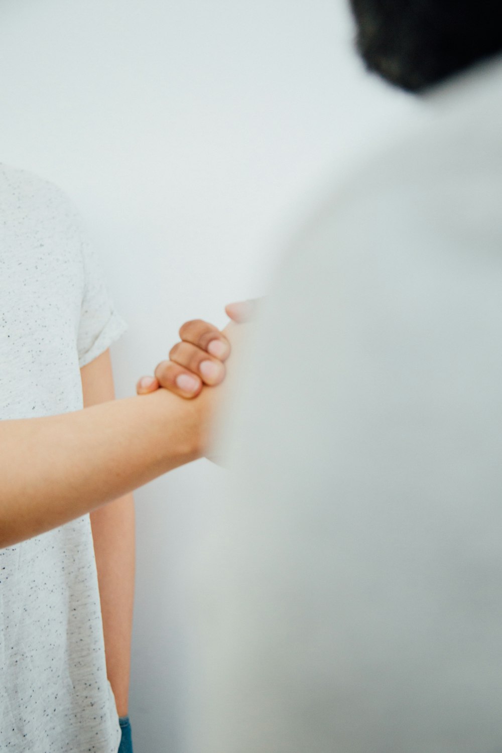 a woman holding a man's hand in a room