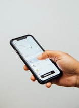 a person holding a cell phone in their hand