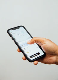 a person holding a cell phone in their hand