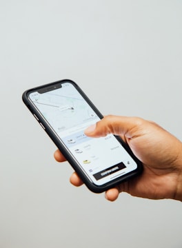 a person holding a cell phone in their hand
