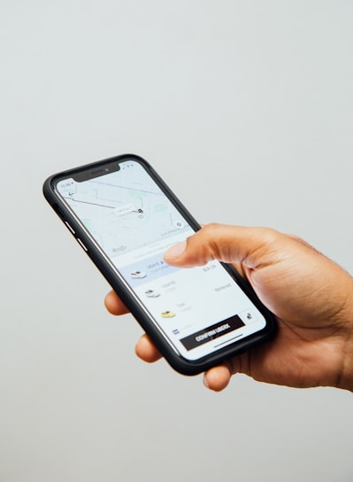 a person holding a cell phone in their hand