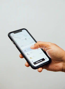 a person holding a cell phone in their hand
