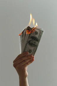 Close-up of hands holding a stack of utility bills and refund notices.