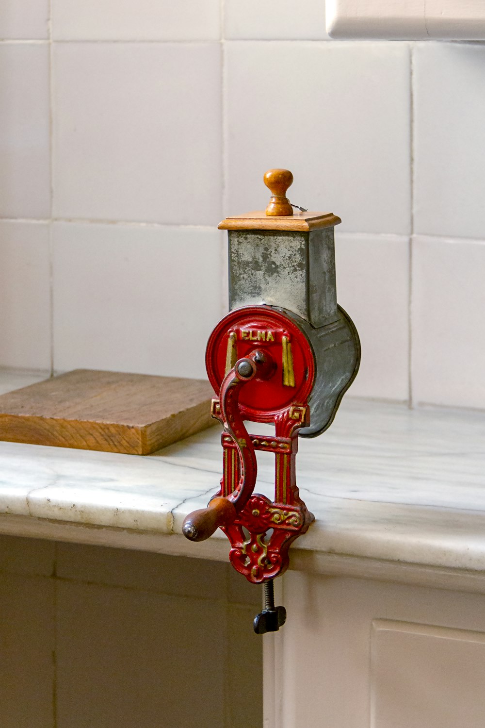 gray and red metal tool on desk