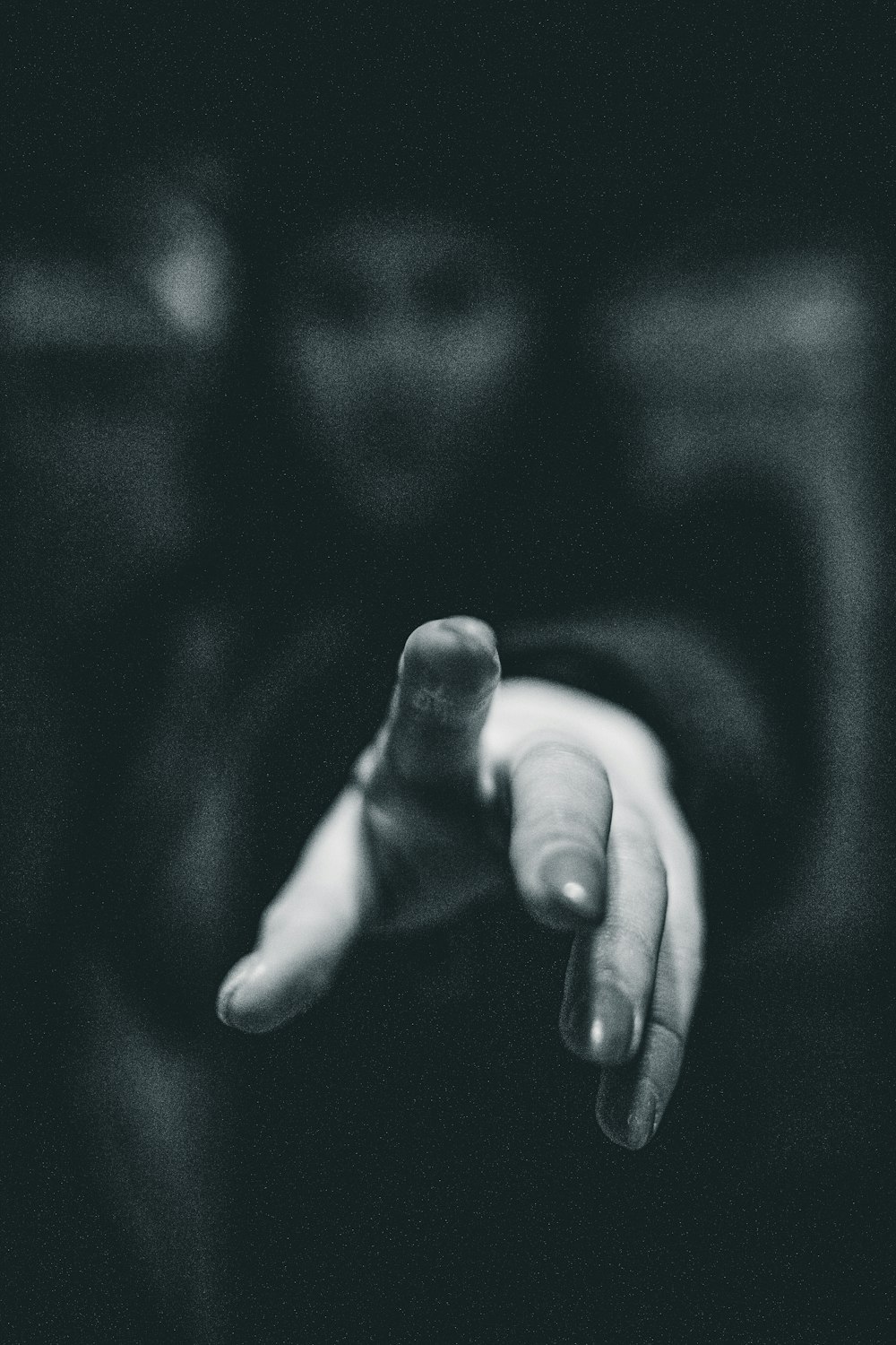a black and white photo of a person pointing at something