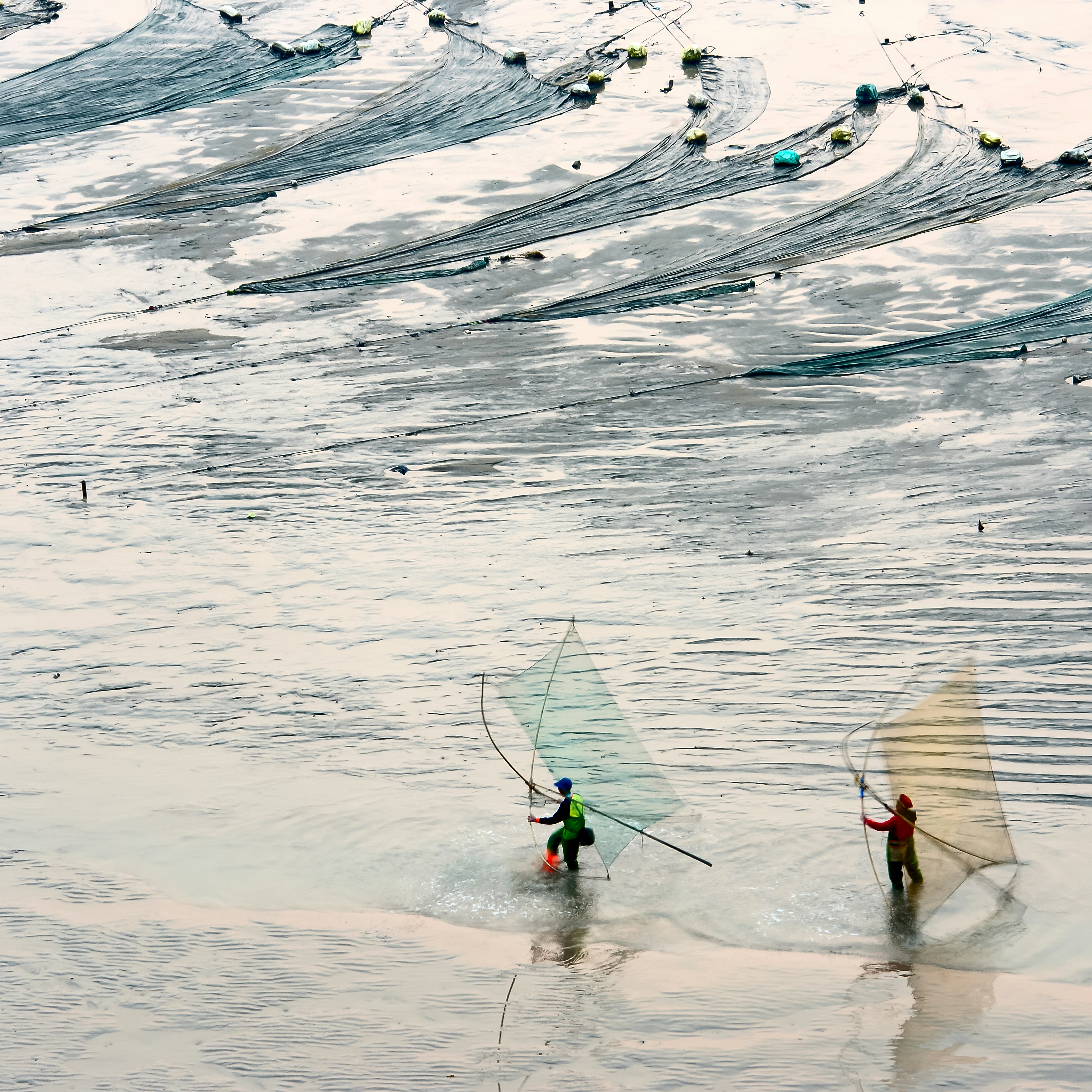 two person fishing during daytime