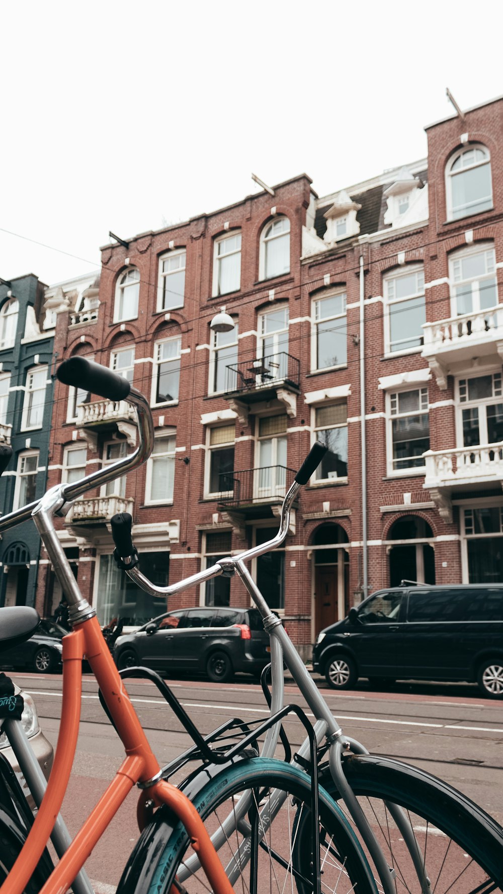 parked vehicles and bicycles near buildings and road